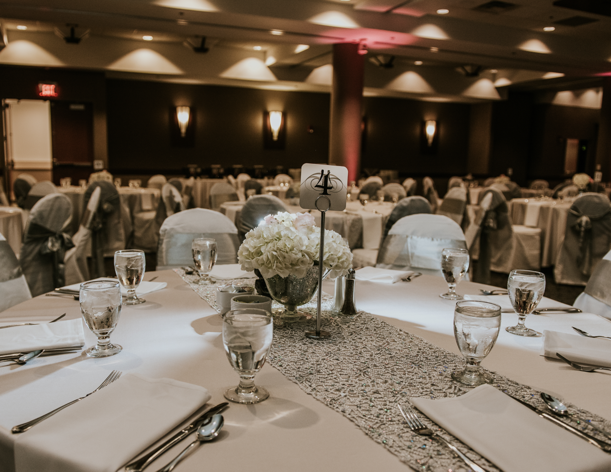 Banquet room with silver decorations and chair covers